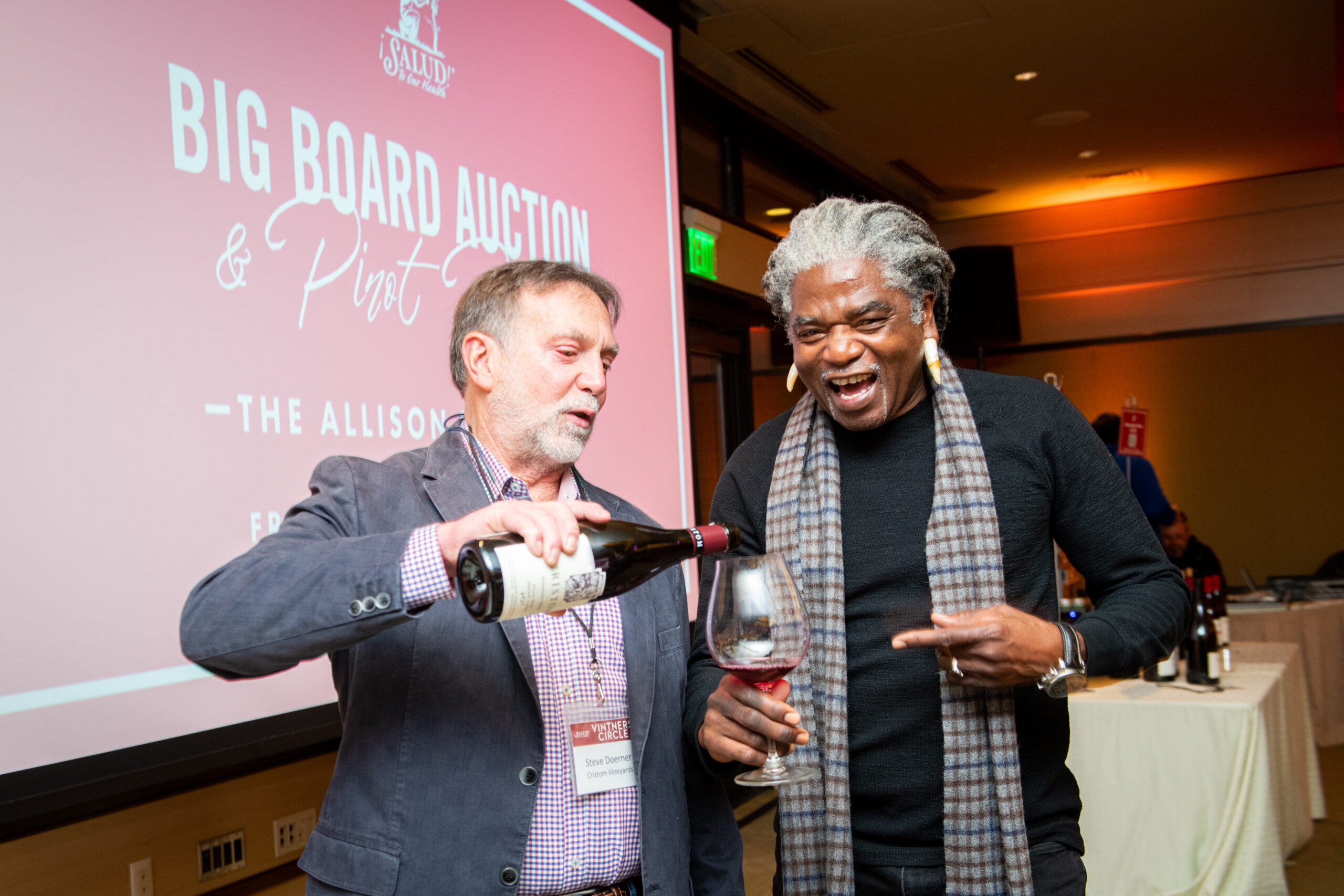 Two people enjoying wine at the 2022 auction