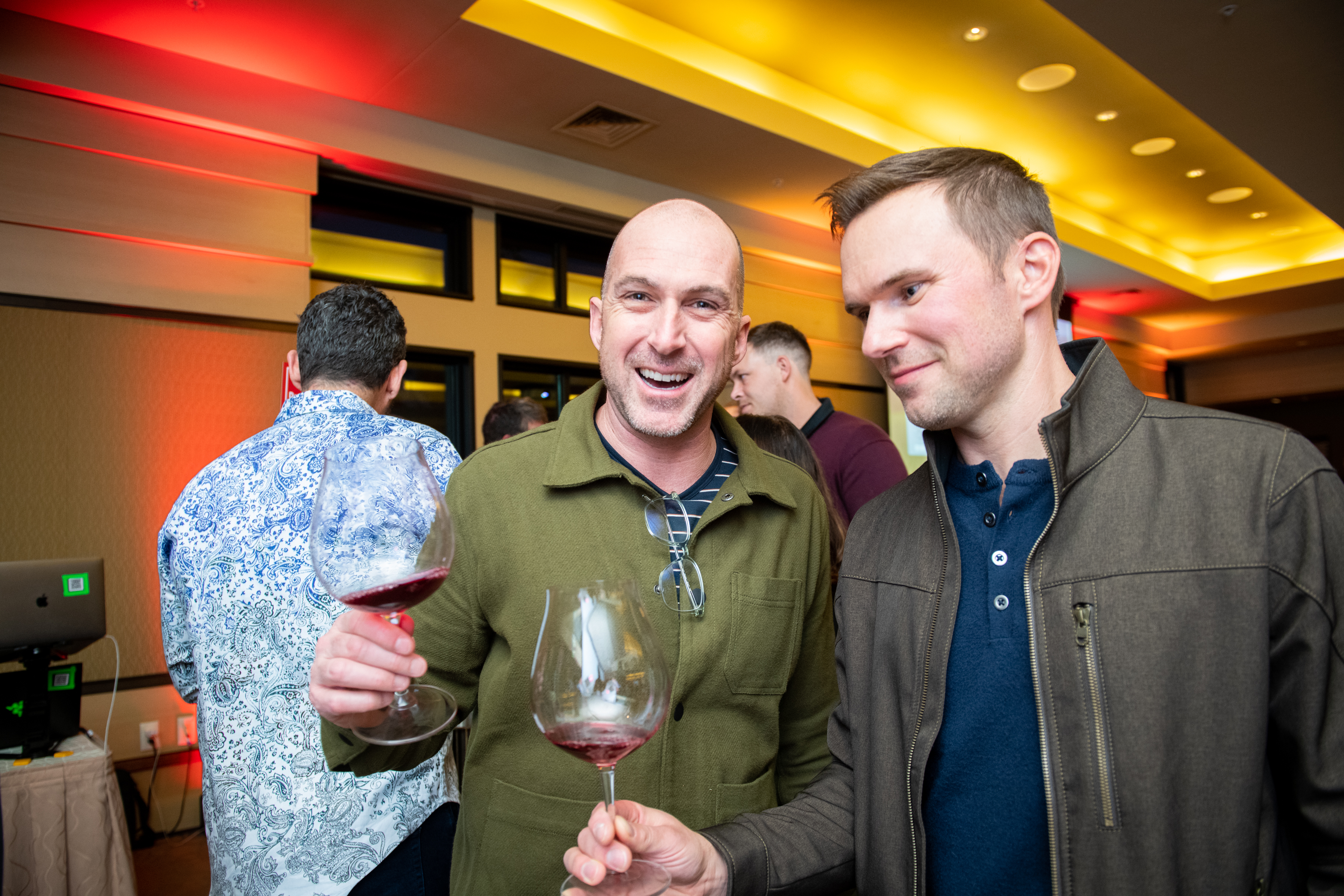 Two men posing at a wine event