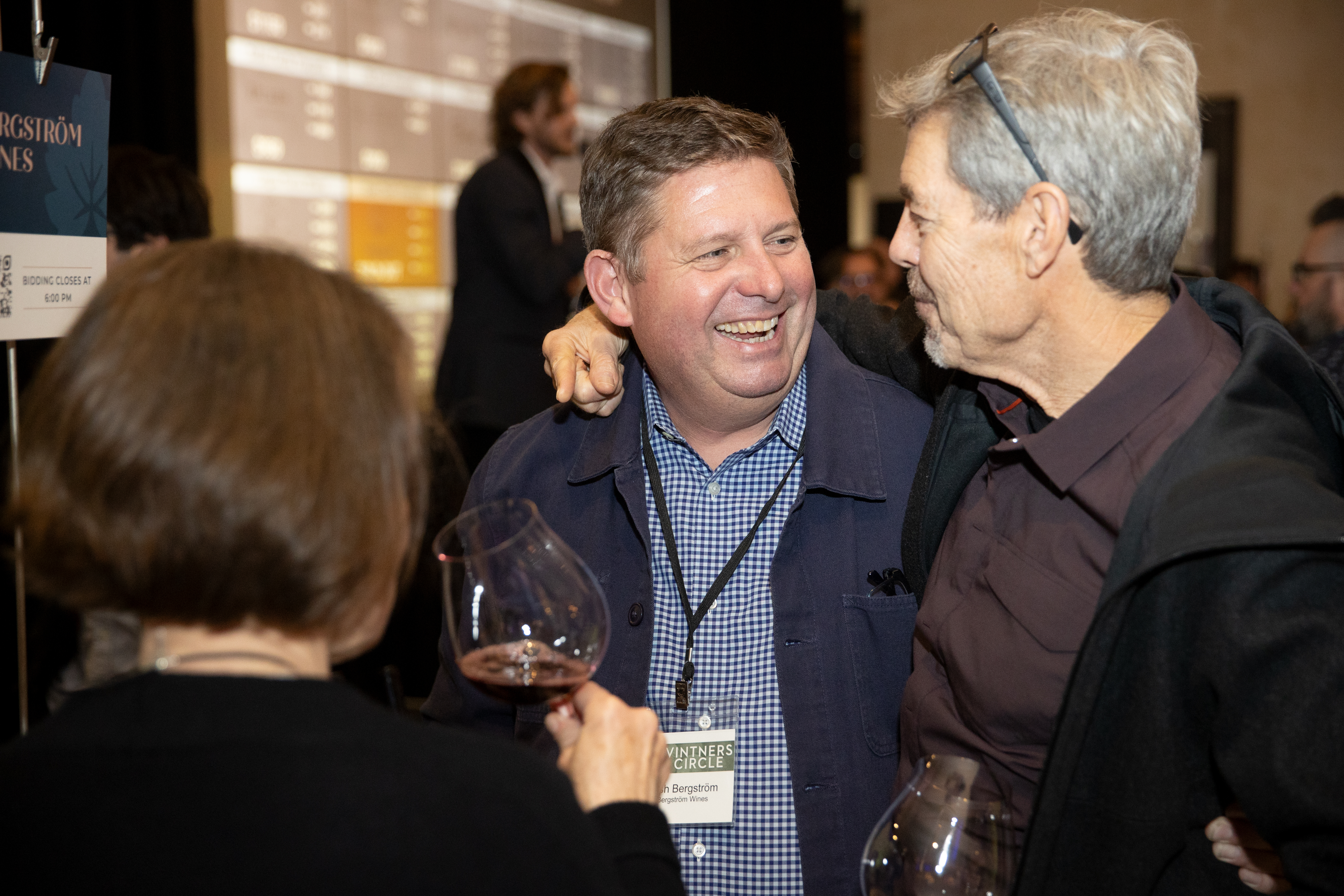 people embracing and enjoying wine