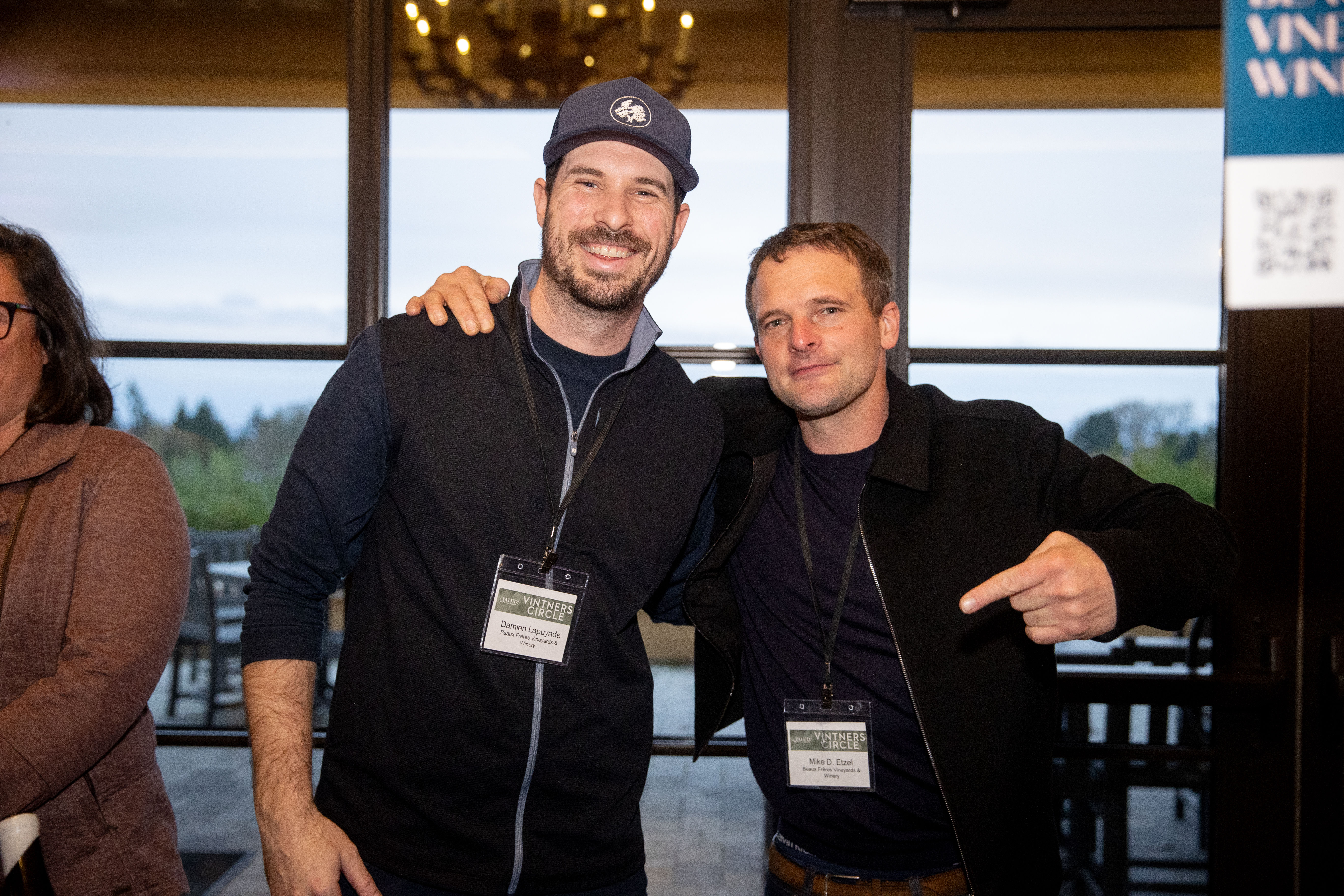 Two men posing at a wine event